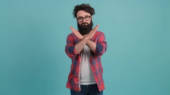 Young Man with Big Beard with Bad Attitude Making Stop Sign Crossing Hands