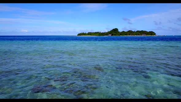 Aerial drone shot seascape of exotic coast beach trip by blue lagoon with bright sandy background of