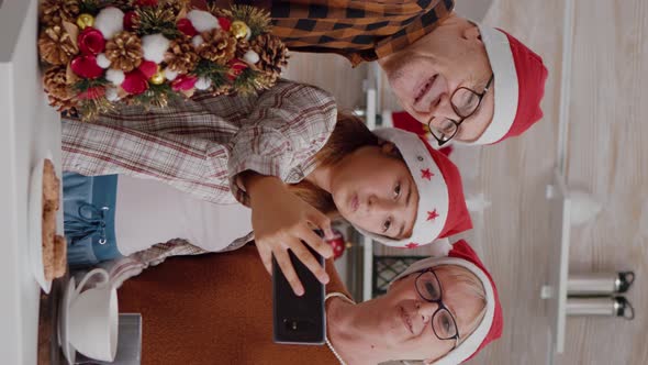 Vertical Video Granddaughter Taking Selfie Using Smarphone with Grandparents During Christmas