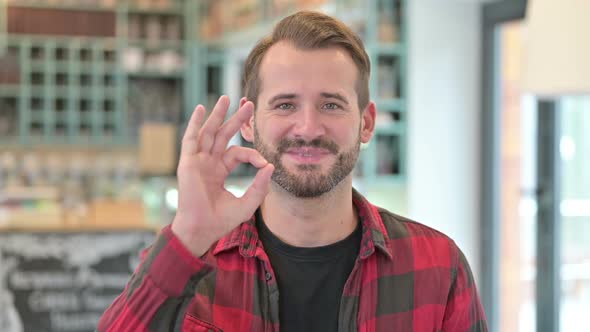 Portrait of Ok Sign By Approving Young Man