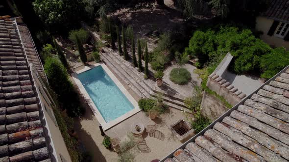 aerial view from the roof of a villa in the south of France on its private garden terrace with swimm
