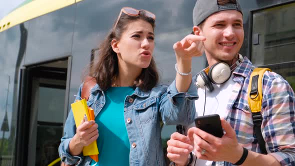 Cheerful Smiling Man Helping Lost Girl Tourist To Find Way. Lost Girl Tourist To Find Way