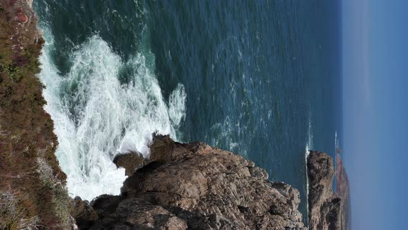 Vertical Video of Sagres Coastline, Algarve, Portugal. Ridged Cliffs Above Ocean, Static View