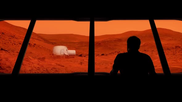 Astronaut Looks Out At Mars Base