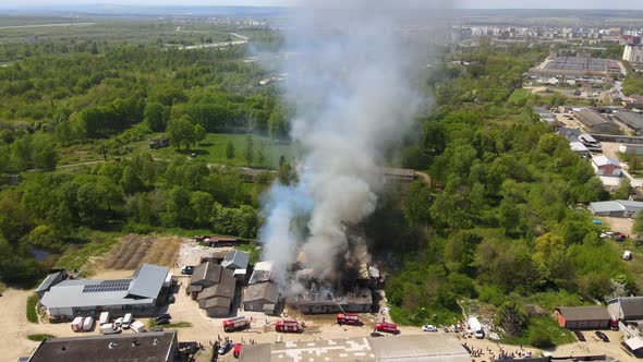 Aerial View of Firefighters Extinguishing Ruined Building on Fire with Collapsed Roof and Rising