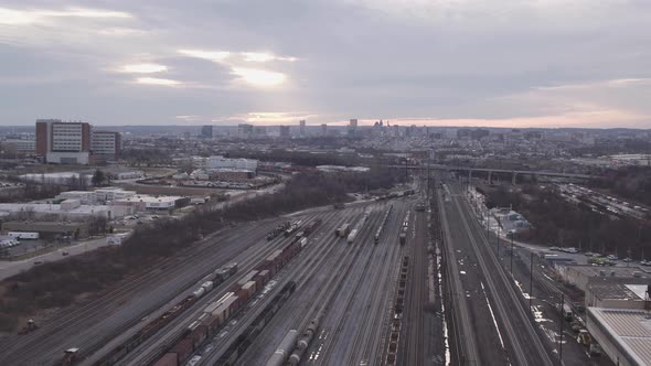 Overview clip of sunrise over the horizon of a train yard