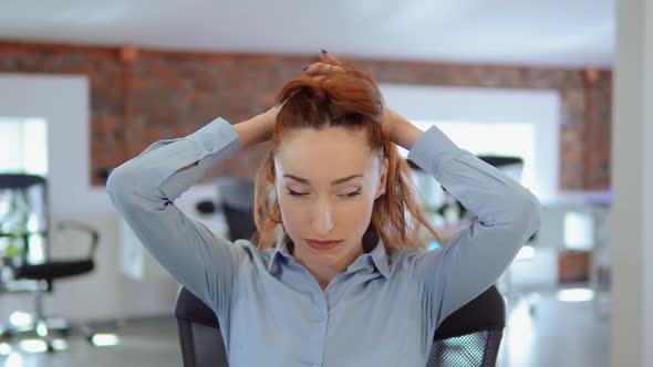 Redhead Businesswoman Has a Migraine at Work