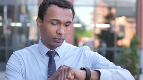 African Businessman Using Smartwatch Outdoor