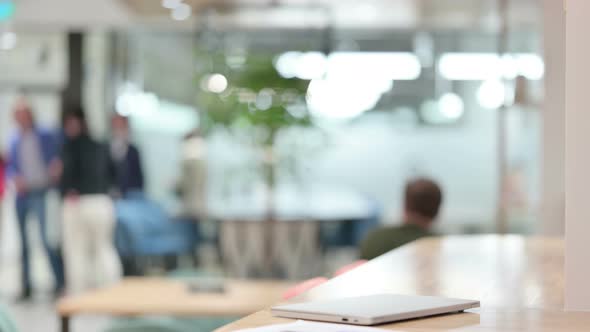 Young Businessman Coming and Opening Laptop 