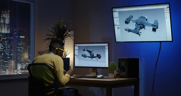 Young Man Sitting Back and Editing an Image on His Computer