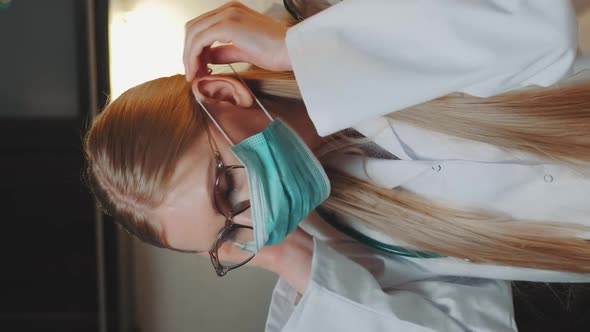 Female Doctor Showing How To Wear Medical Mask By Video Call on Computer