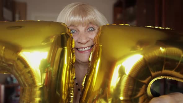 Cute Grandma Celebrates Her Birthday. Holds Balloons in Her Hands