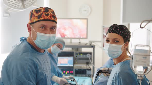 Surgeon Looking at Camera with Colleagues