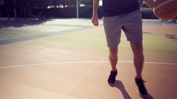 Closeup View of Basketball Player Dribbling the Ball on the Basketball Playground