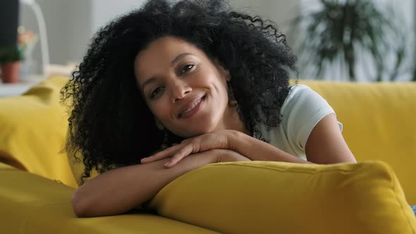 Portrait of a Young African American Woman Looking at the Camera and Smiling Cute