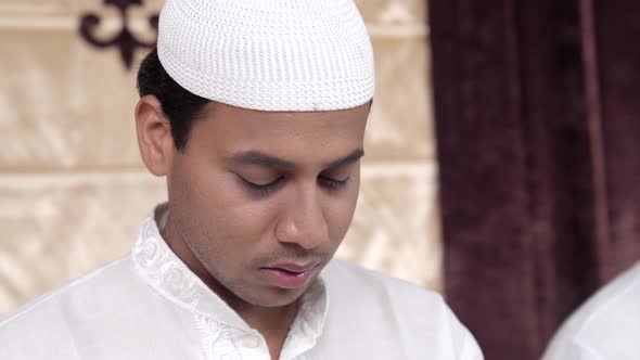 Muslim man chating prayers
