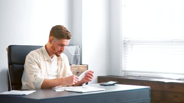 Professional bank accountant looks at different receipts