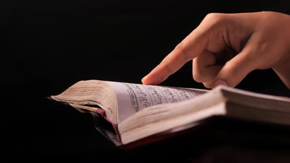 Muslim Women's Hand Reading Quran at Night 