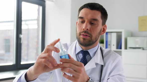 Doctor with Sanitizer Having Video Call at Clinic