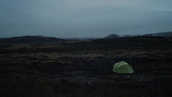 iceland, volcanic landscape with a pitched camping tent, camera movement, camera pan from left to ri