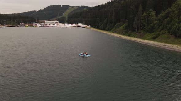 Two people out in a paddle boat at beautiufl adventure resort in Ukraine, Europe