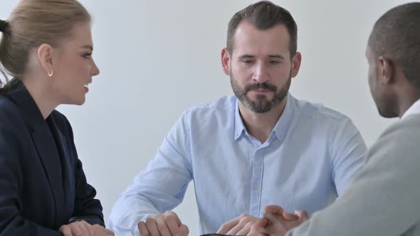 Serious Business People Having Discussion in Office