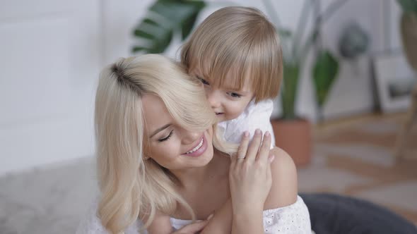 Young Woman with Her Son in the Bedroom