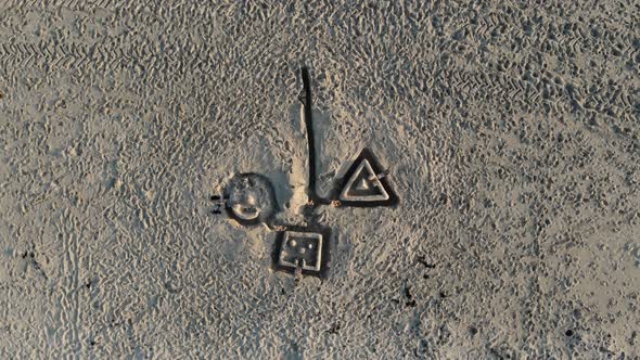 Aerial, screwdriver, drone shot, above drawing on sand