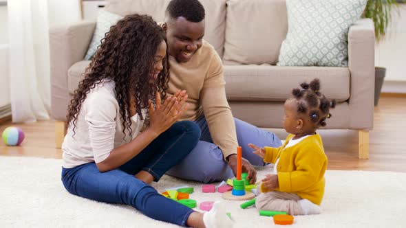African Family Playing with Baby Daughter at Home