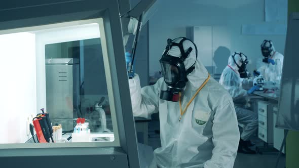 Laboratory Analysis Is Being Done By an Expert in a Hazmat Suit