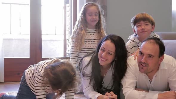 Happy Family of Mom Dad and Tree Children Have Fun at Home During Quarantine