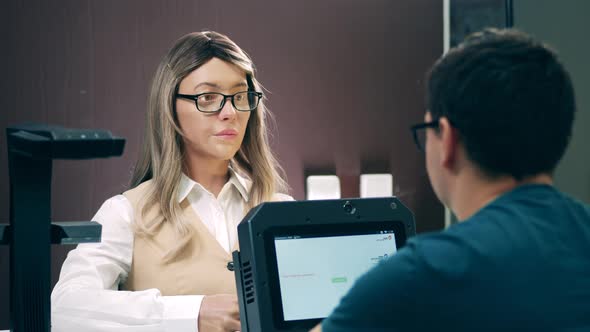 Male Client Is Talking To a Female Humanlike Robot