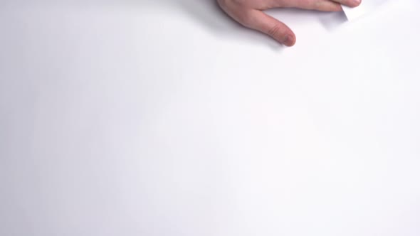 Male Hand Flips a White Sheet of Paper on a Green Screen.