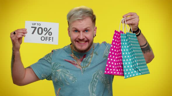 Cheerful Tourist Man Showing Shopping Bags and Up To 70 Percent Off Inscriptions Banner Black Friday