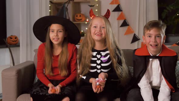 Kids in Halloween Costumes Throw Candies at Home