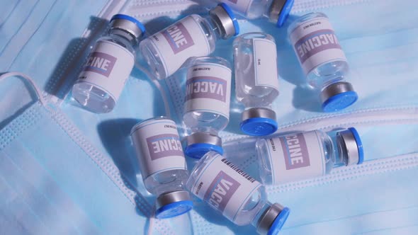 Group of vaccine bottles on face masks.