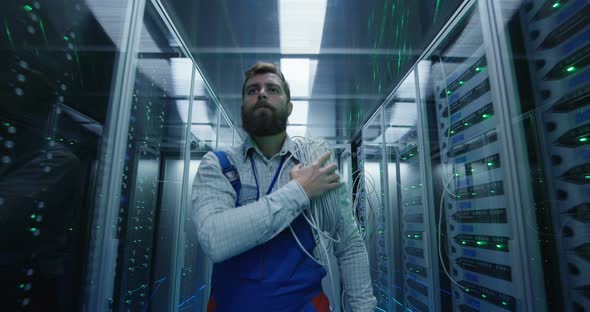 Male Technician Working in a Data Center
