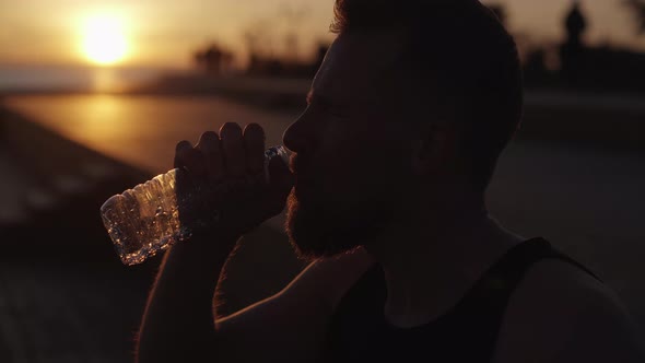 Epic Shot of Wriggling Face of Tired Sportsman Pouring Water on Head Closeup