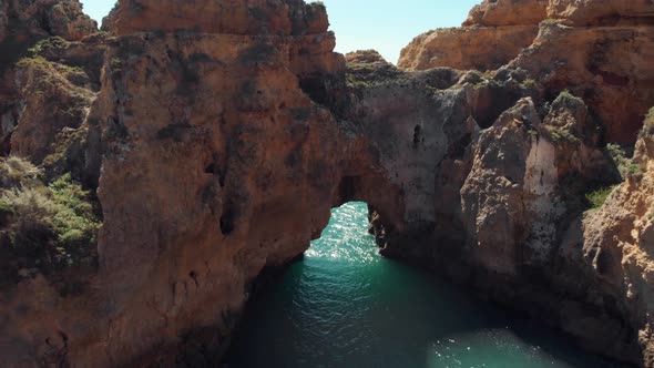 Ponta da Piedade cliffs and rocks against ocean water and horizon, Algarve region, Portugal.