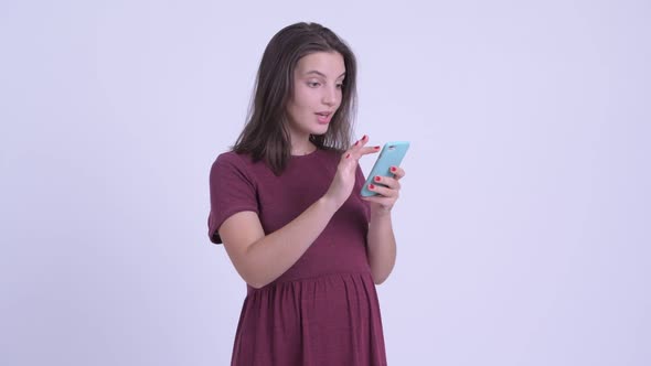 Happy Young Beautiful Pregnant Woman Using Phone and Getting Good News