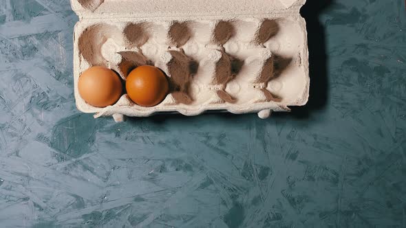 Stop Motion Of Two Organic Eggs Moving Around In An Egg Tray, overhead shot