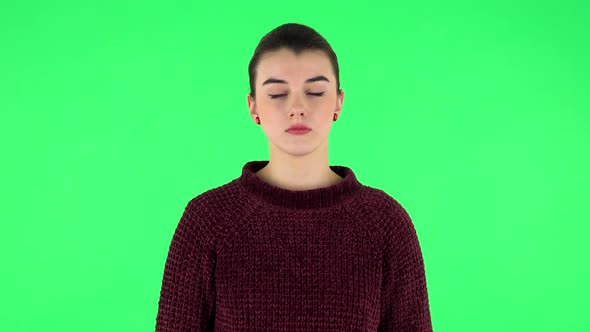 Woman Standing and Looks at the Camera. Green Screen