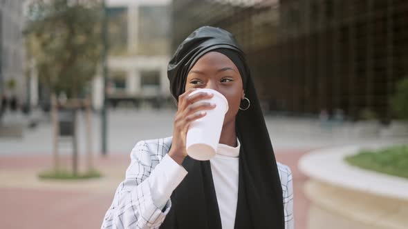Merry Muslim Woman in Park in Downtown