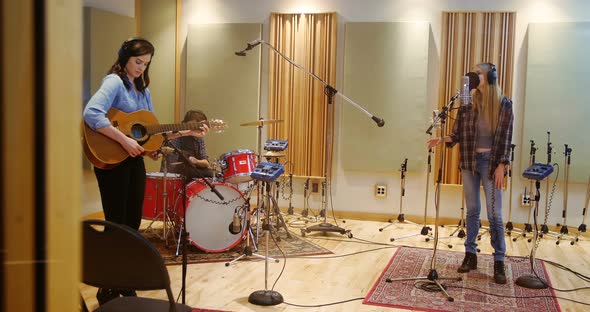 Music band performing in a studio