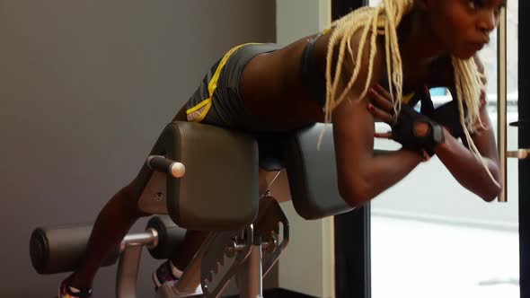 Fit woman exercising on a machine