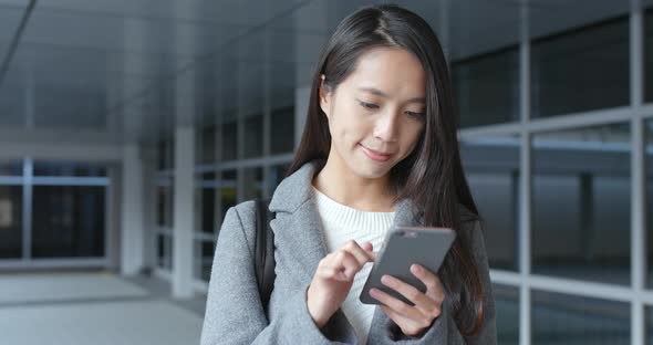 Woman use of mobile phone in city