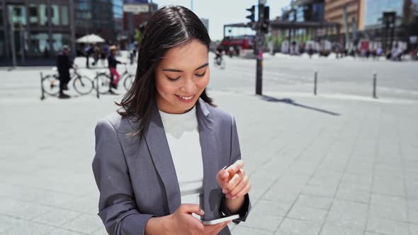 Smiling Young Asian Businesswoman Holding Smartphone Using Mobile Apps Tech