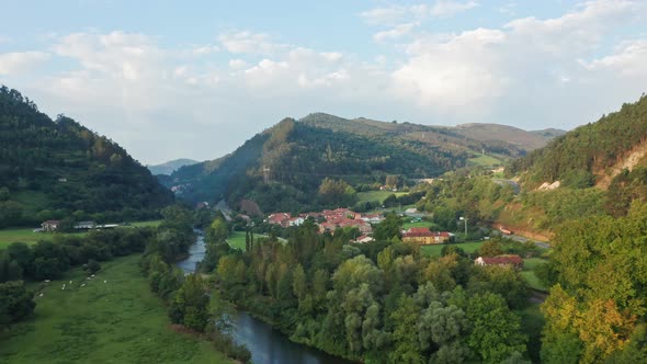 Aerial Drone Top Notch view above Riocorvo Cartes River, in Besaya Valley, Cantabria, North of Spain