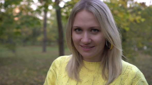 Portrait of a Young Woman in an Autumn Park