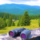 Hiking Sticks And Binoculars On The Wooden Table, Mountain Valley On A Background - VideoHive Item for Sale